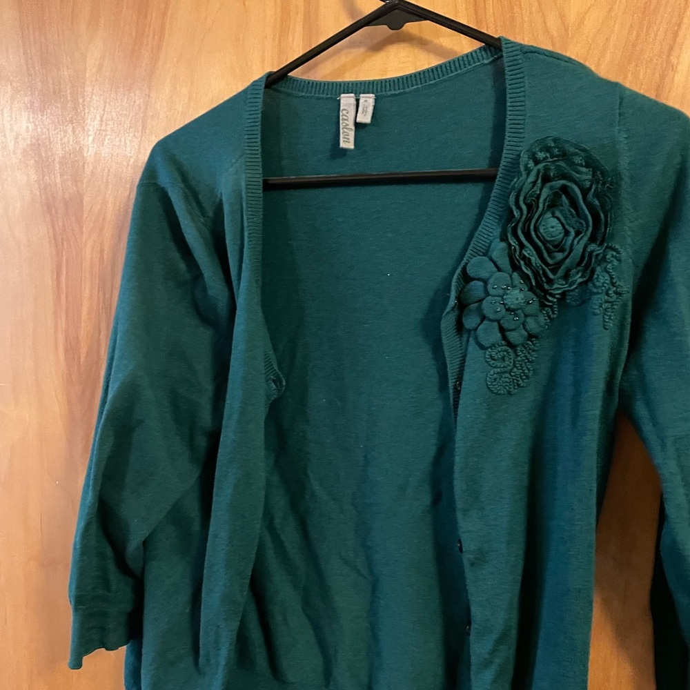 Caslon cardigan, in like a forest green, with a flower detail on one side.